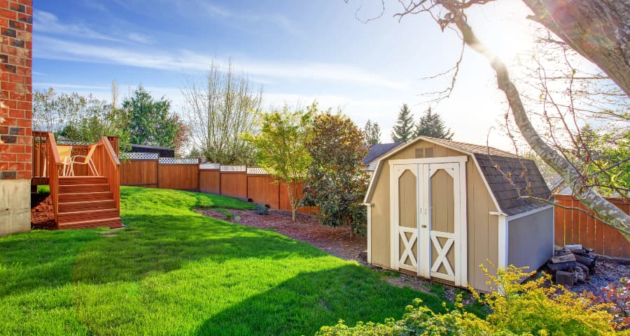 Fenced backyard with storage shed in Asheville